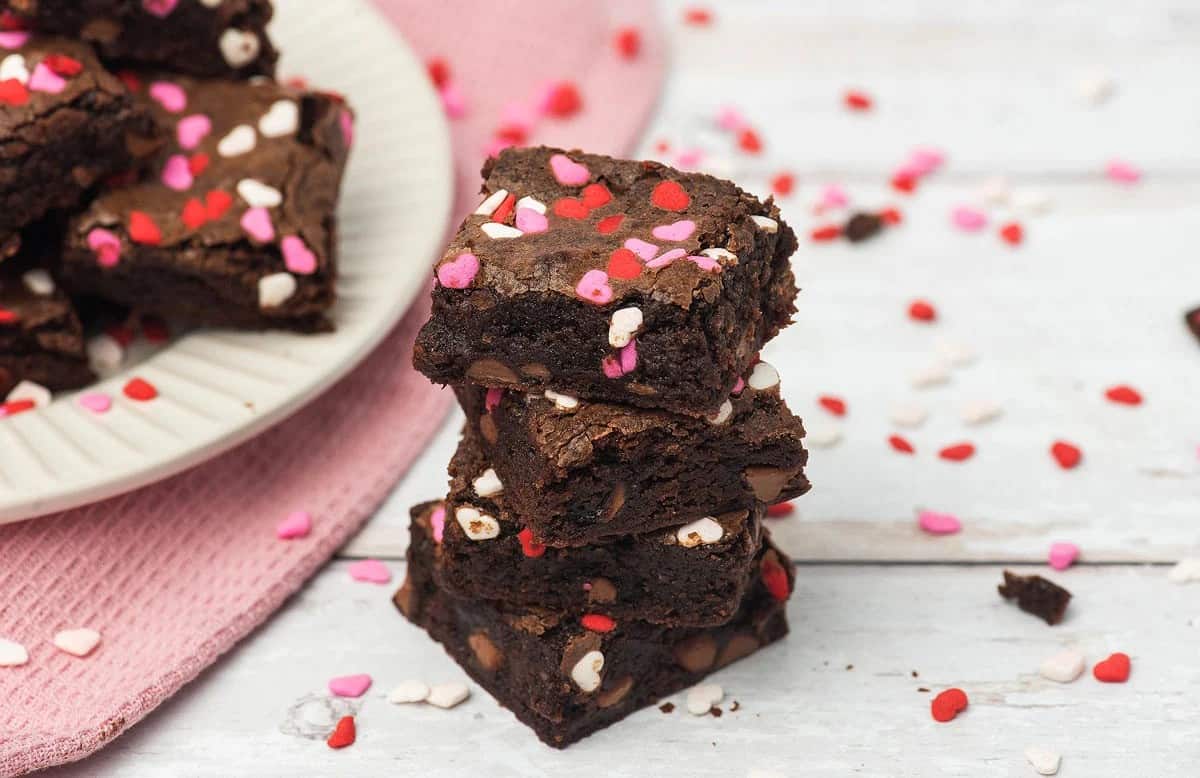 A stack of brownies with sprinkles on top.