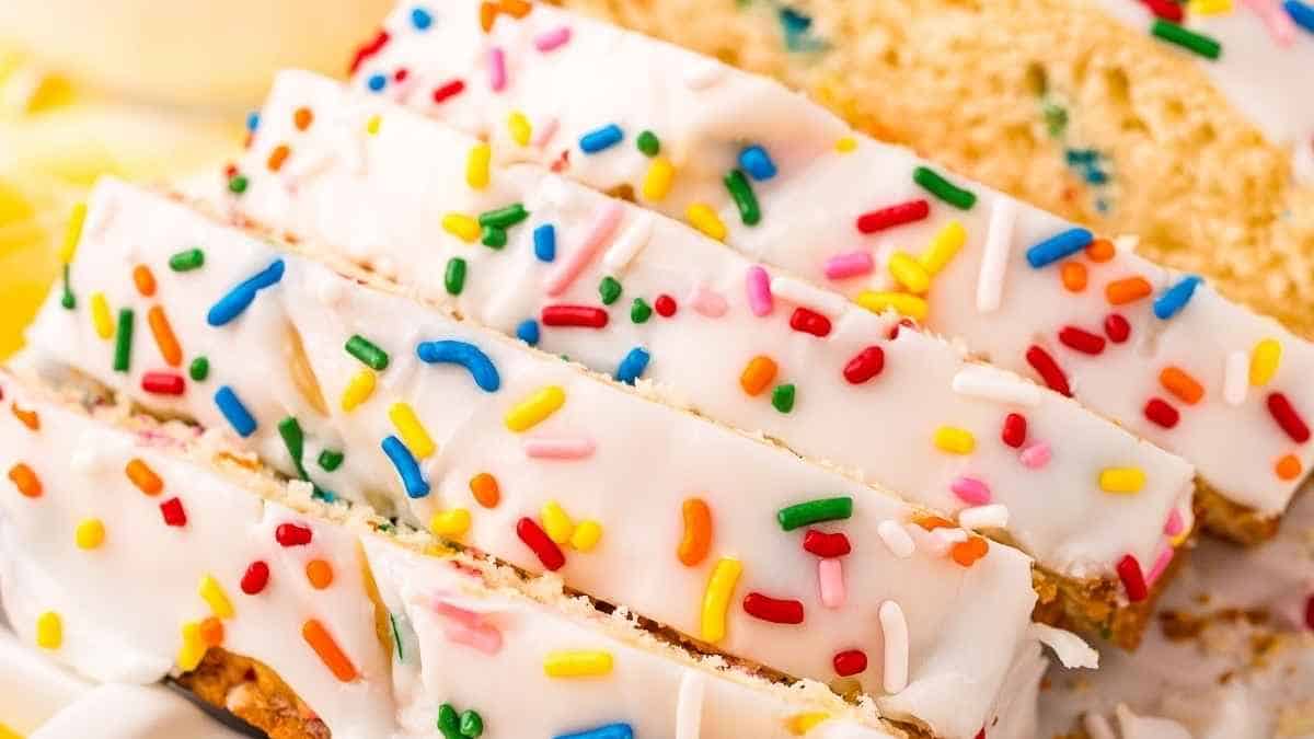 A slice of cake with sprinkles on top.