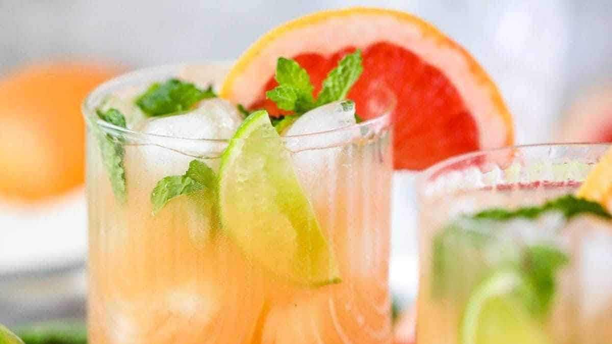Two glasses of grapefruit mojito with lime and mint.