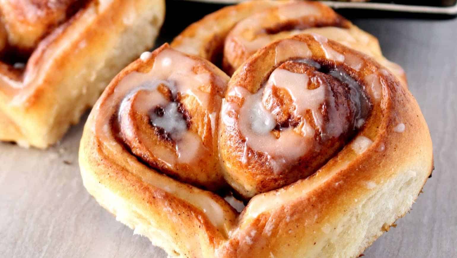 Cinnamon rolls on a plate with icing.