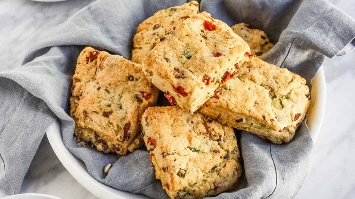 Savoury scones in a bowl with a cup of coffee.