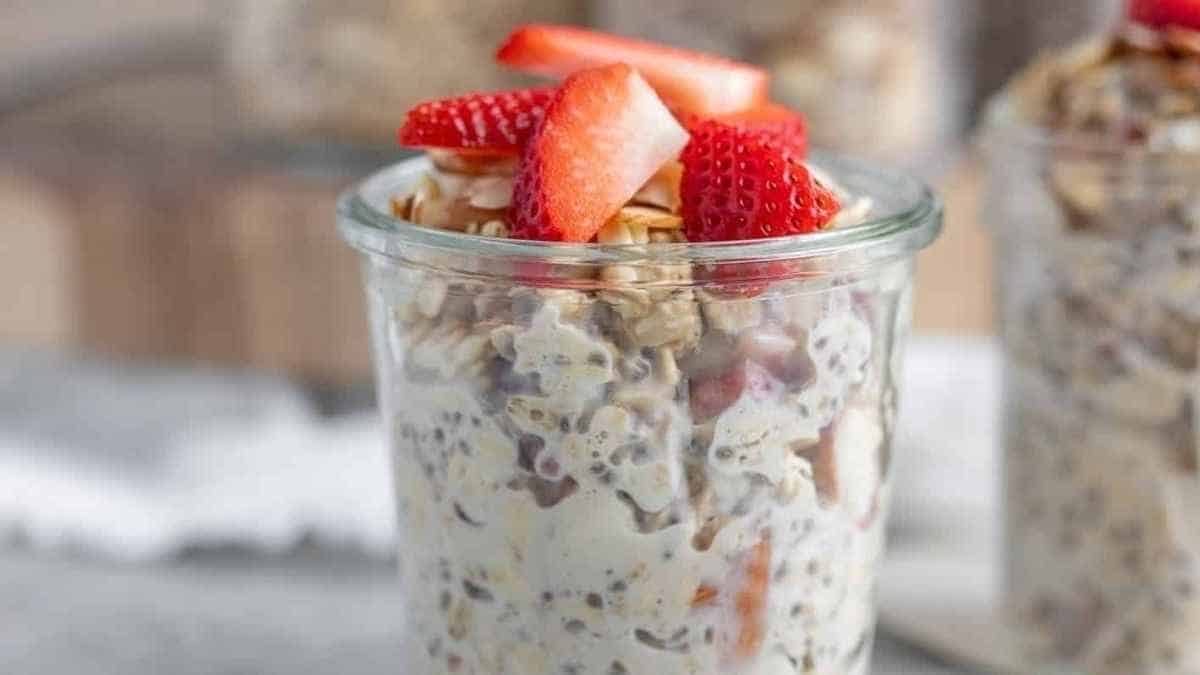Strawberries and oats in a glass jar.