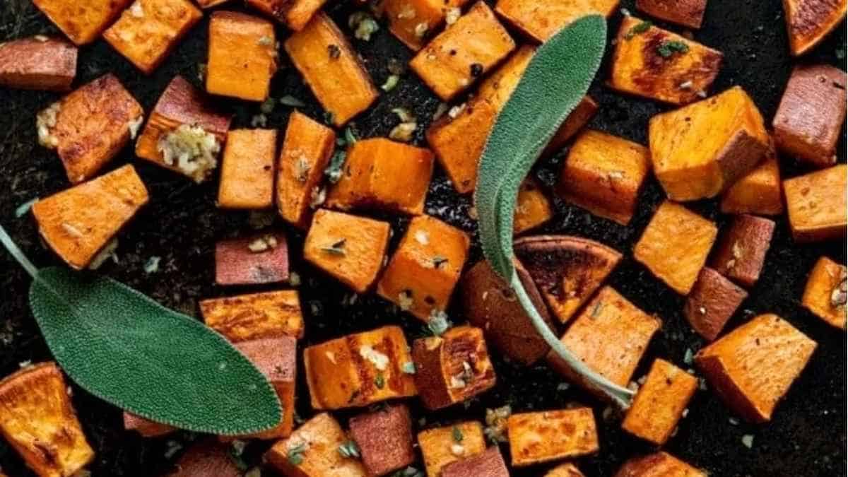 Roasted sweet potatoes with sage leaves.