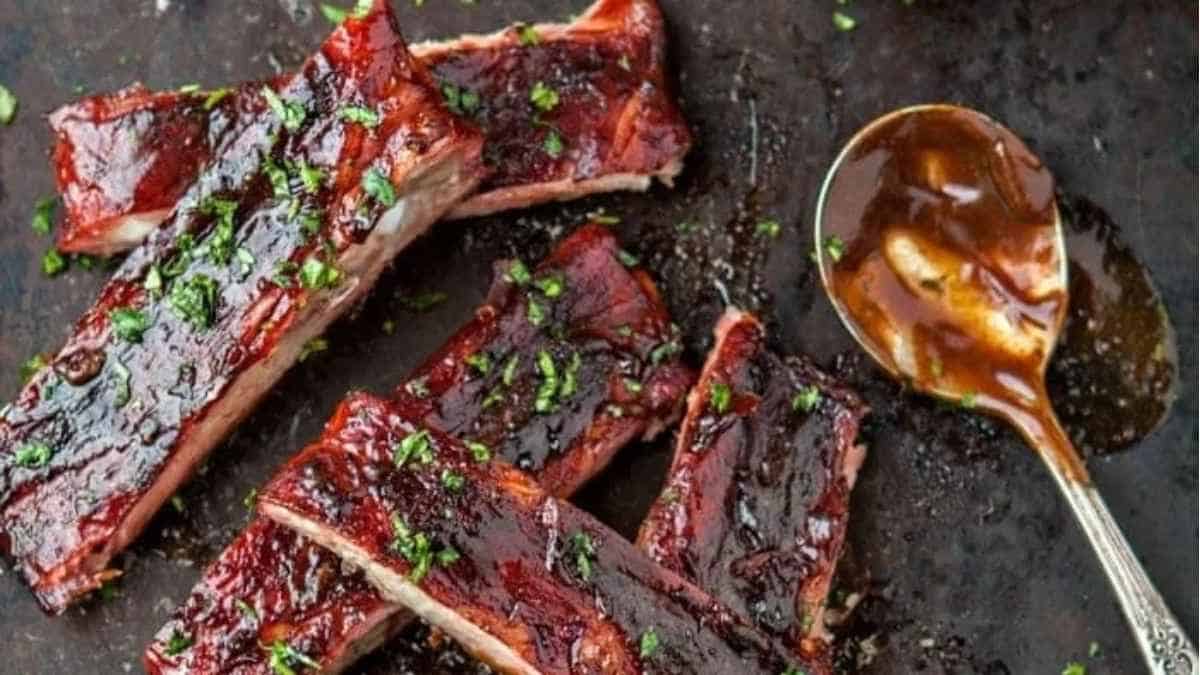 Bbq ribs with sauce and a spoon.