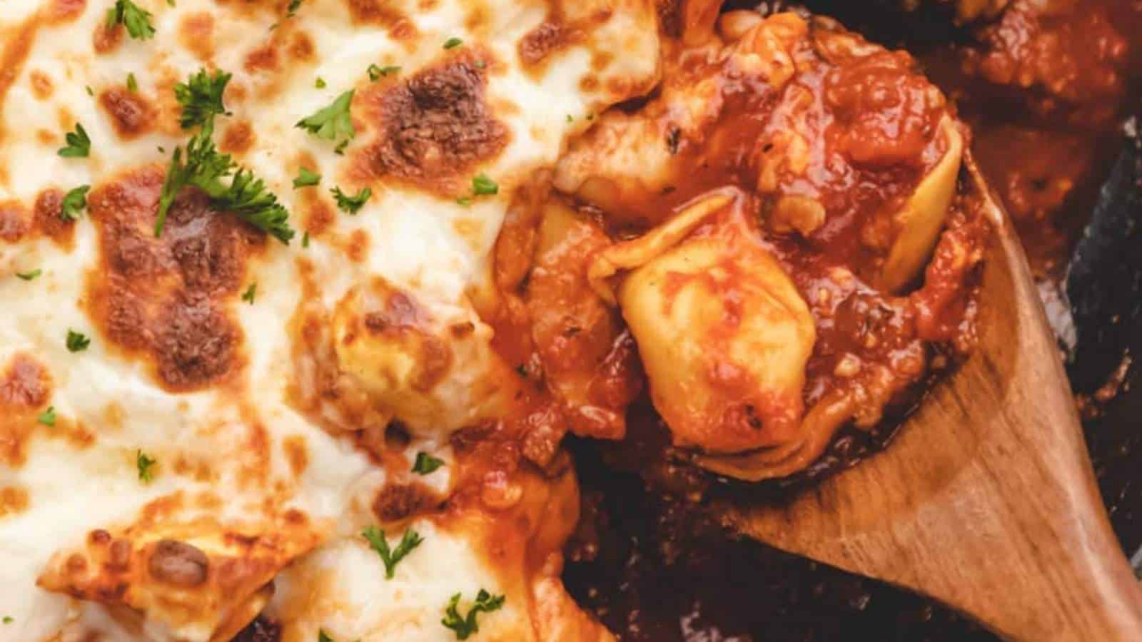 Cheesy lasagna in a skillet with parmesan cheese.