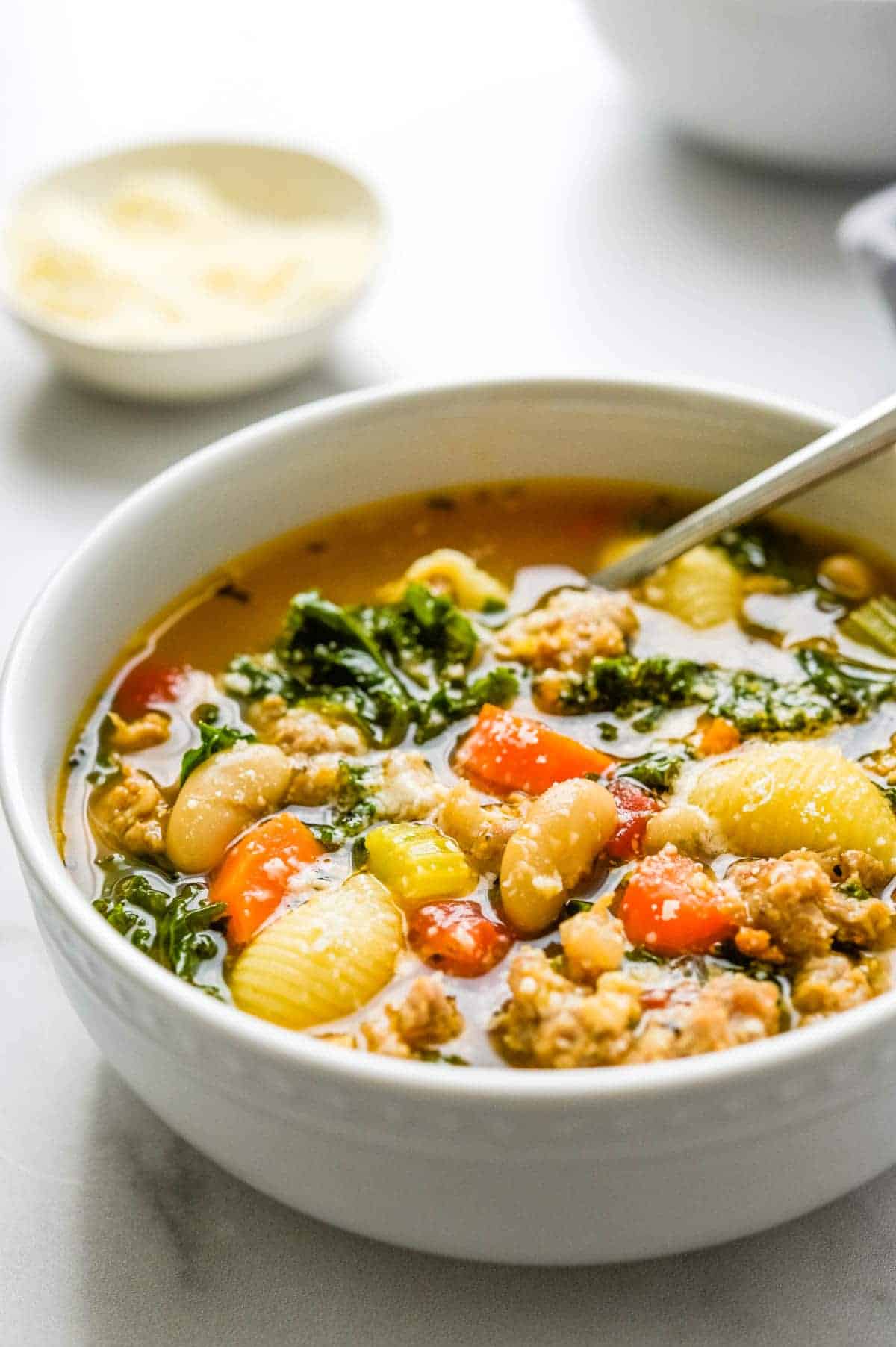 A bowl of hearty soup with tender meat and a medley of fresh vegetables.