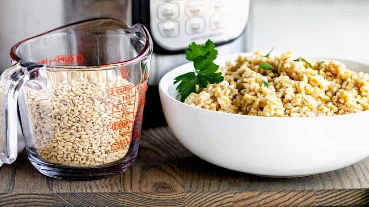 A bowl of brown rice next to an instant pot.