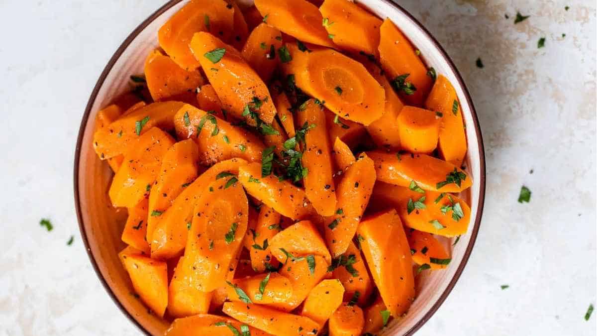 Carrots in a bowl with parsley.
