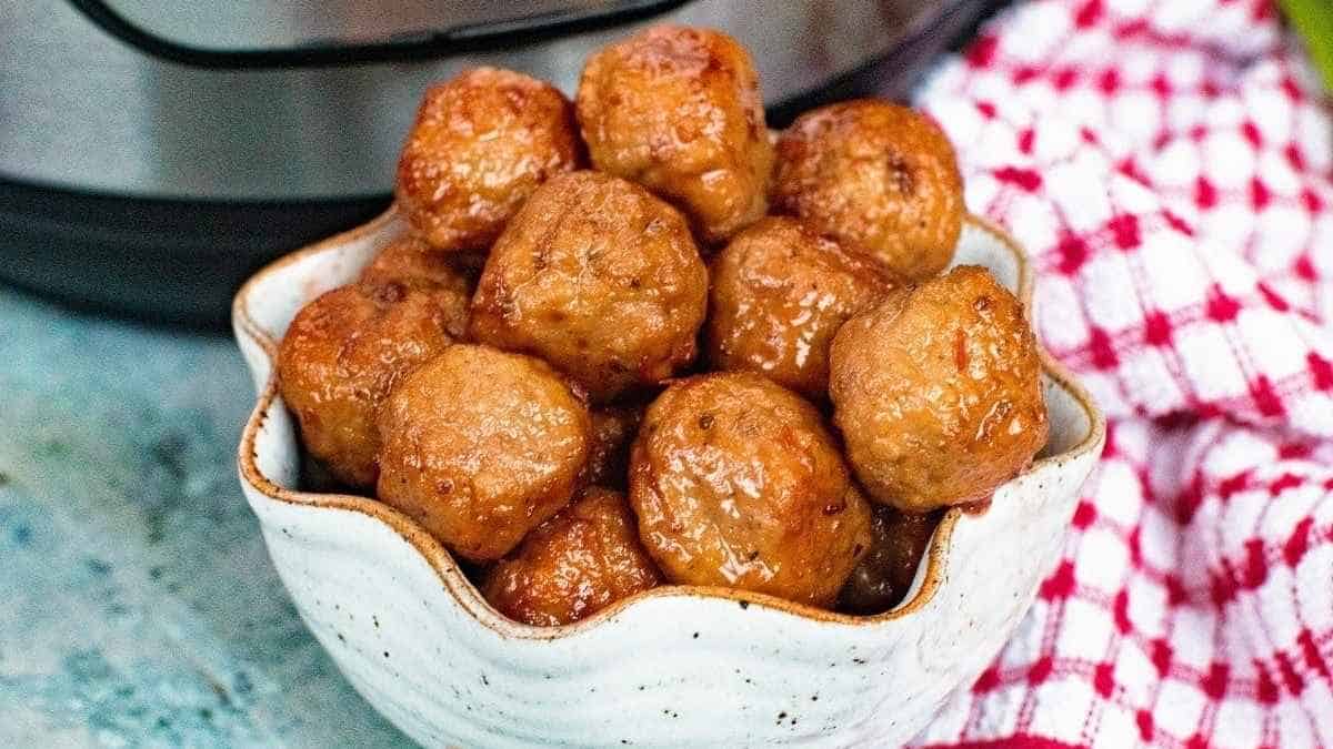 Meatballs in a bowl in front of an instant pot.