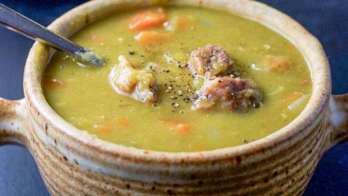A bowl of soup with meat and vegetables in it.