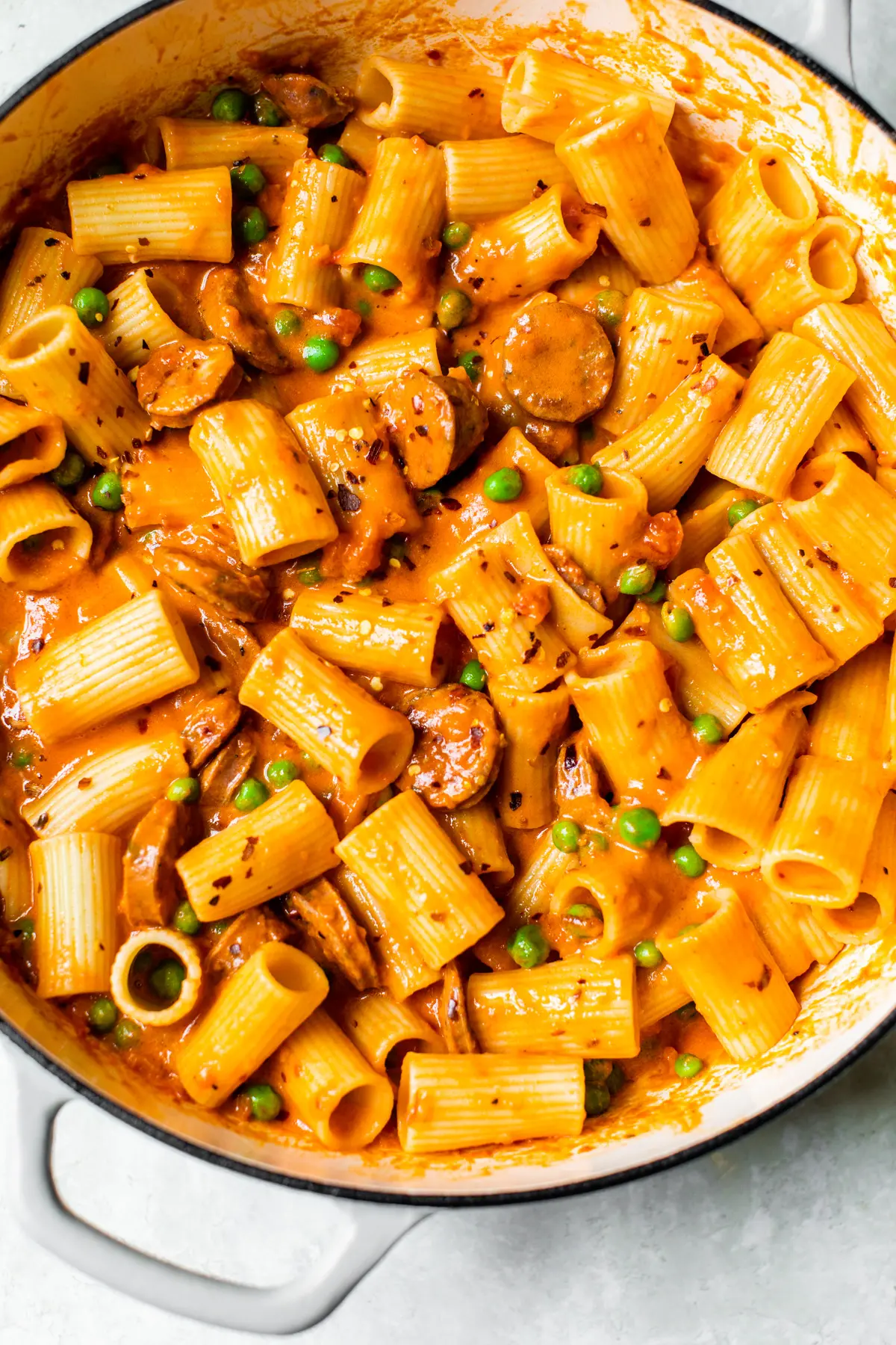 A delicious skillet full of pasta with sausage and peas, perfect for those looking for tasty sausage recipes.