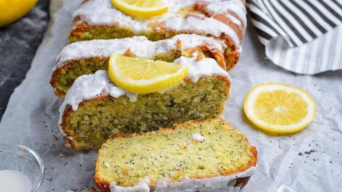 Lemon poppy seed bread with icing and lemon slices.