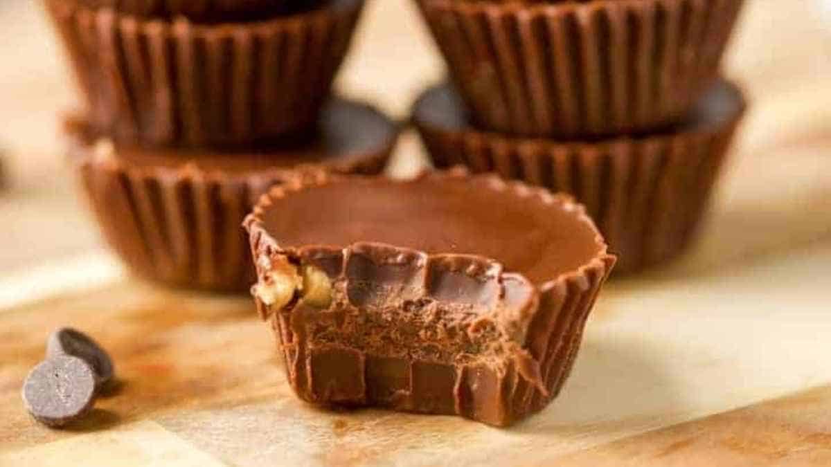 Chocolate peanut butter cups on a wooden cutting board.