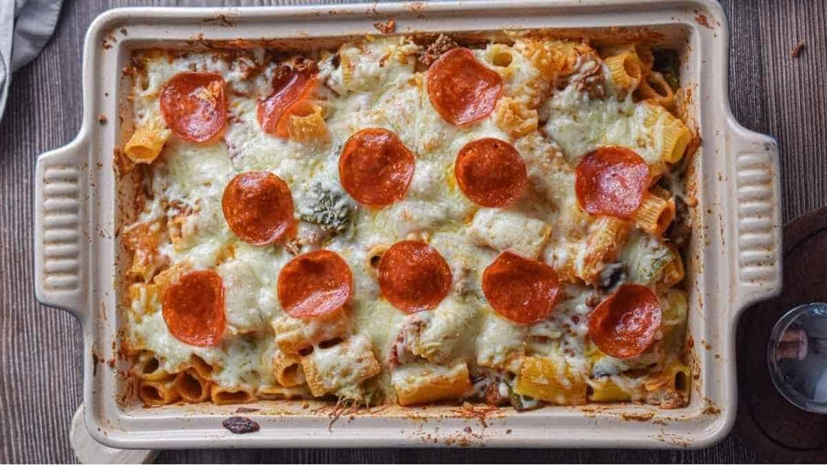 A casserole dish with pepperoni and cheese.