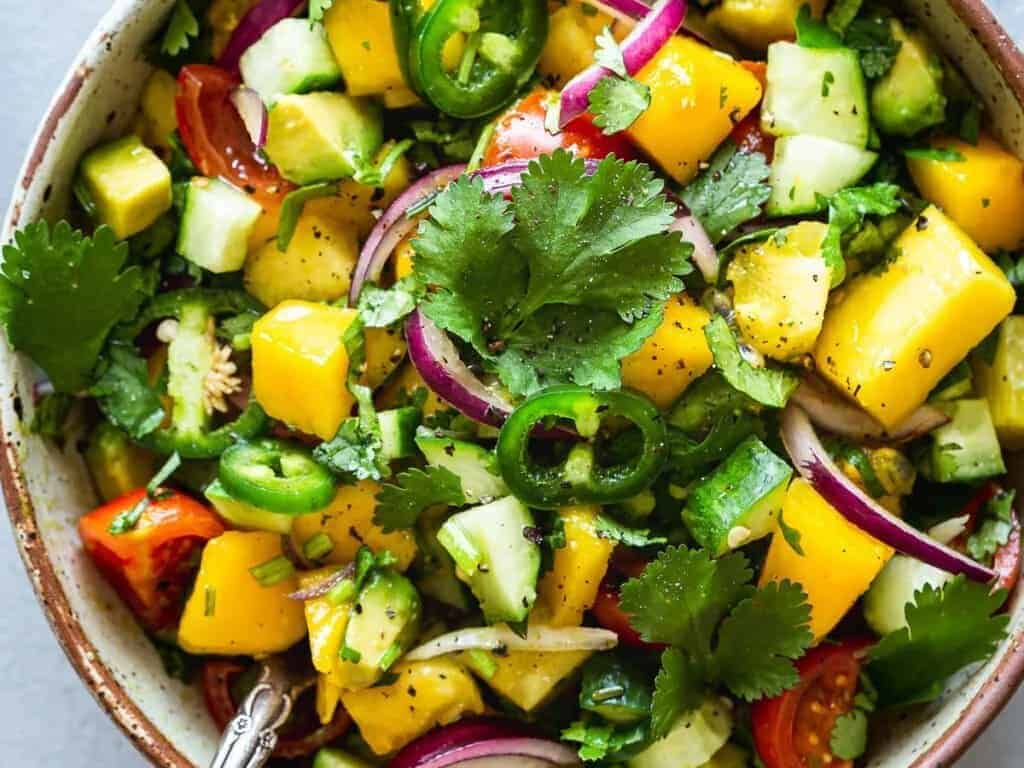 Mango and cucumber salad in a bowl.