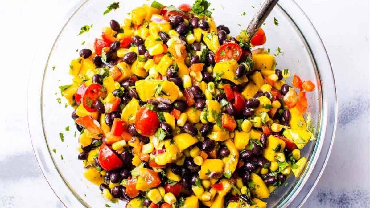 Black bean and corn salad in a bowl with a spoon.