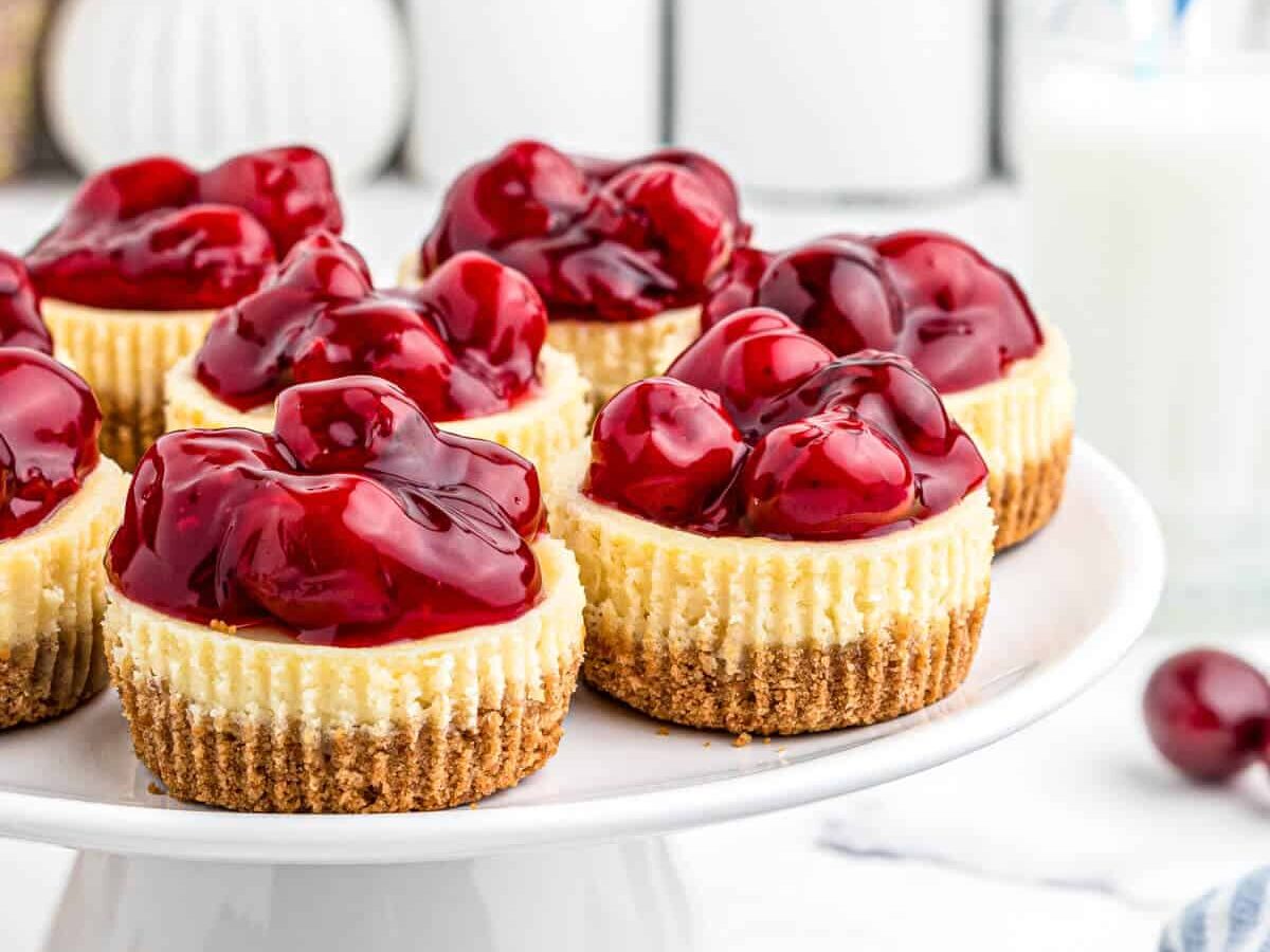 Cherry cheesecakes on a white plate.