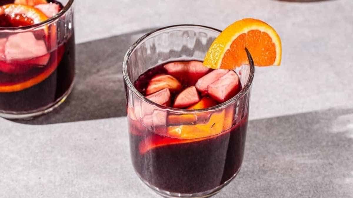 Two glasses of sangria with orange slices.