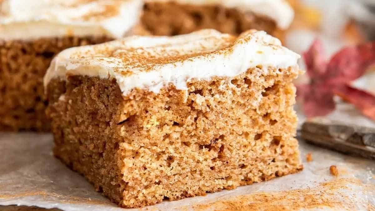 A slice of pumpkin cake on a piece of paper.