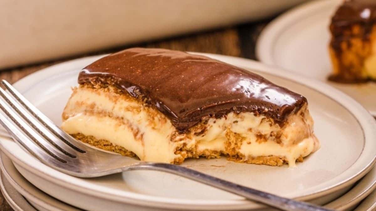 A slice of chocolate cake on a plate with a fork.