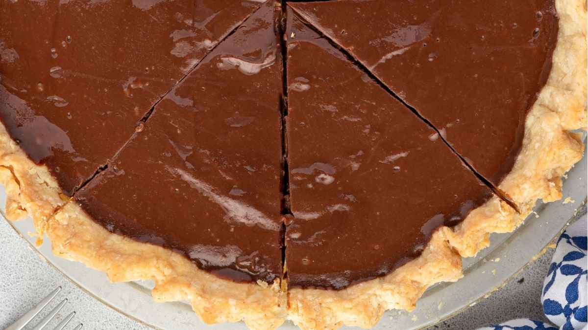 A chocolate pie with a slice taken out.