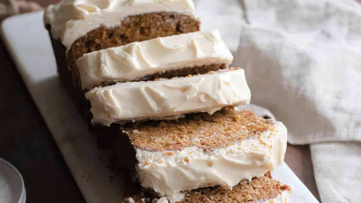 A slice of carrot cake with cream cheese frosting.
