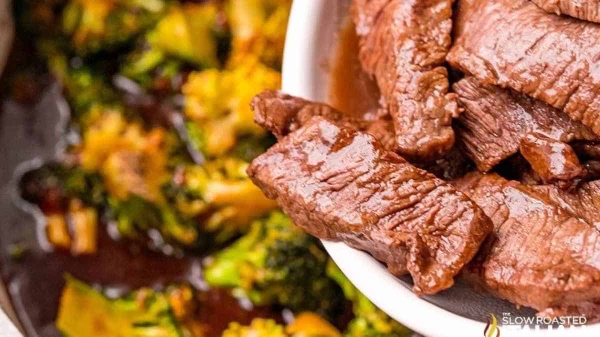 Beef and broccoli in a white bowl.