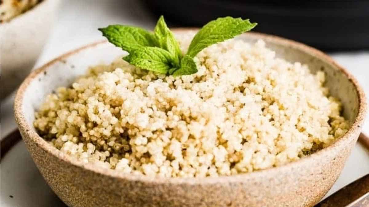 Couscous in a bowl with mint leaves.
