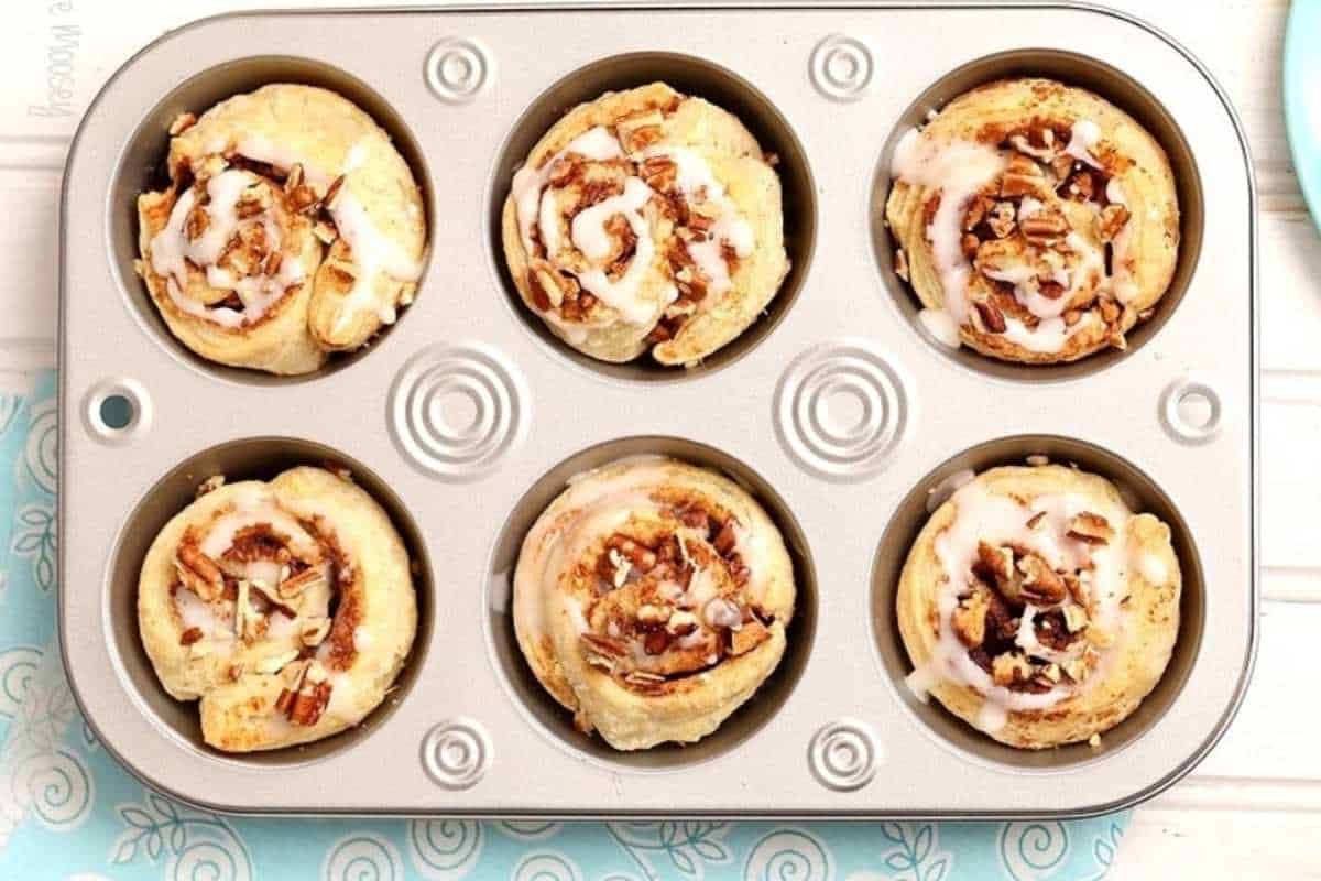 Cinnamon roll muffins in a muffin tin.