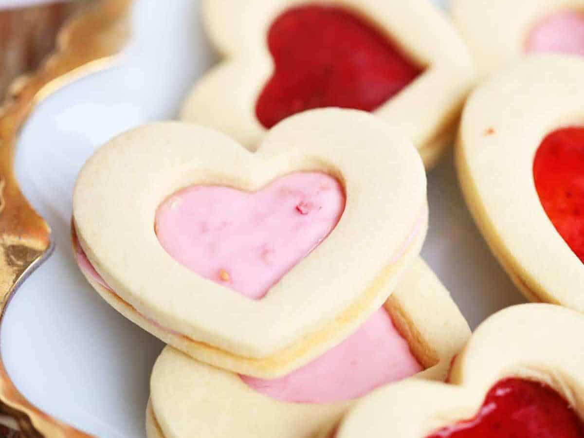Valentine's day cookies with jam and jelly on a plate.