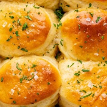 Rolls in a baking dish with parsley on top.