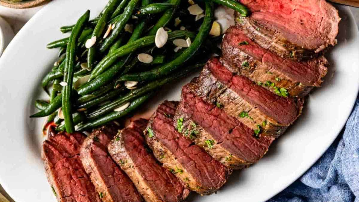 Steak on a plate with green beans.