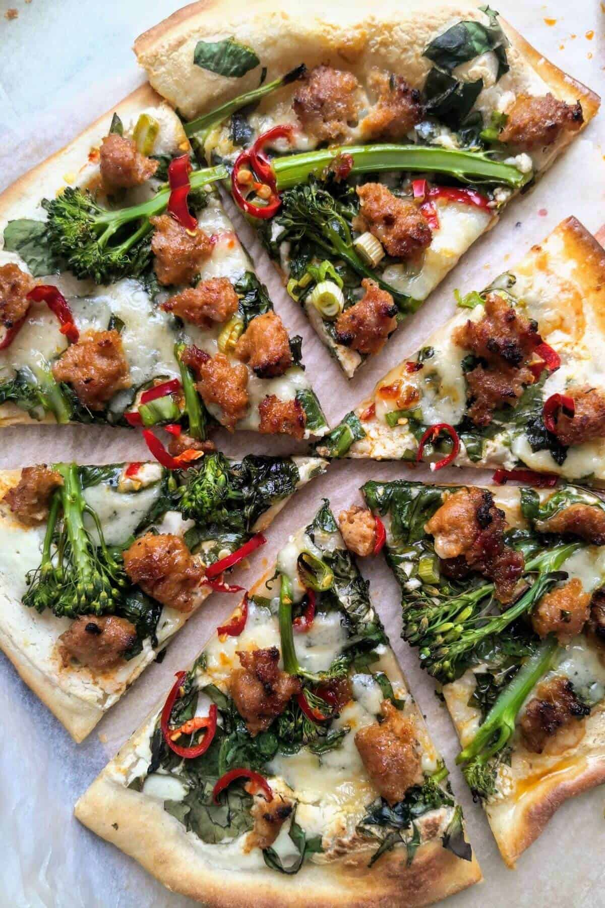 A delicious pizza topped with savory sausage and nutritious broccoli.