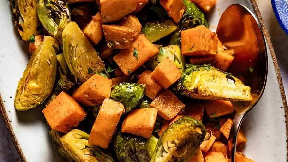 Brussels sprouts and sweet potatoes on a plate.