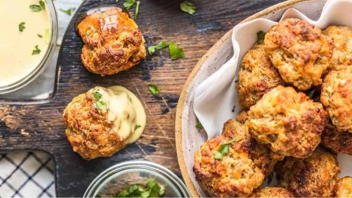 Chicken meatballs in a bowl with dipping sauce.
