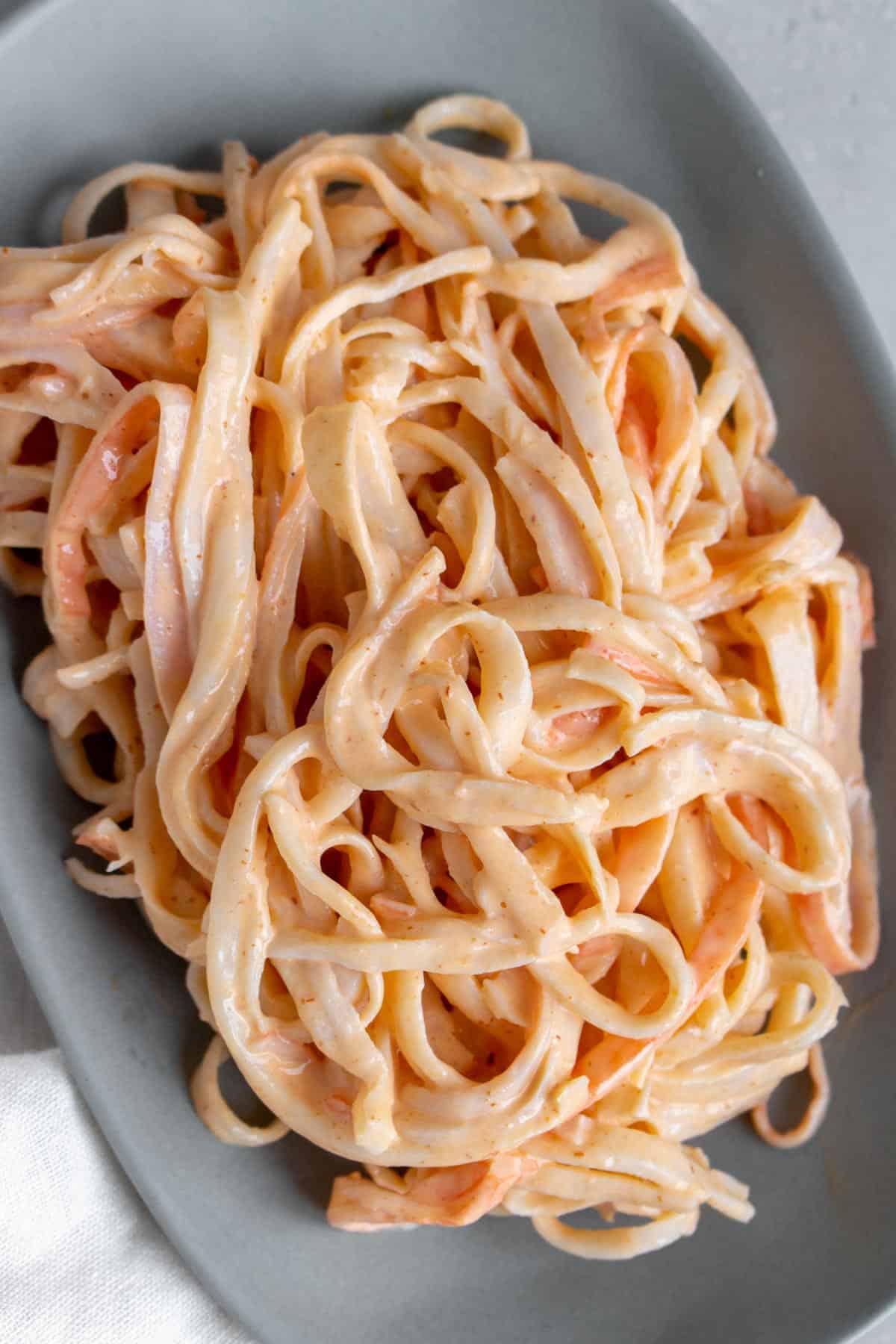 A plate of pasta with imitation crab sauce.