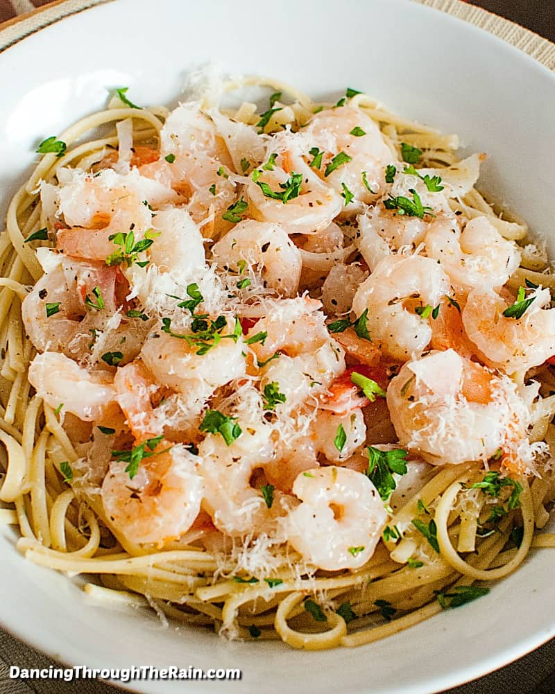 A bowl of pasta with shrimp and imitation crab.