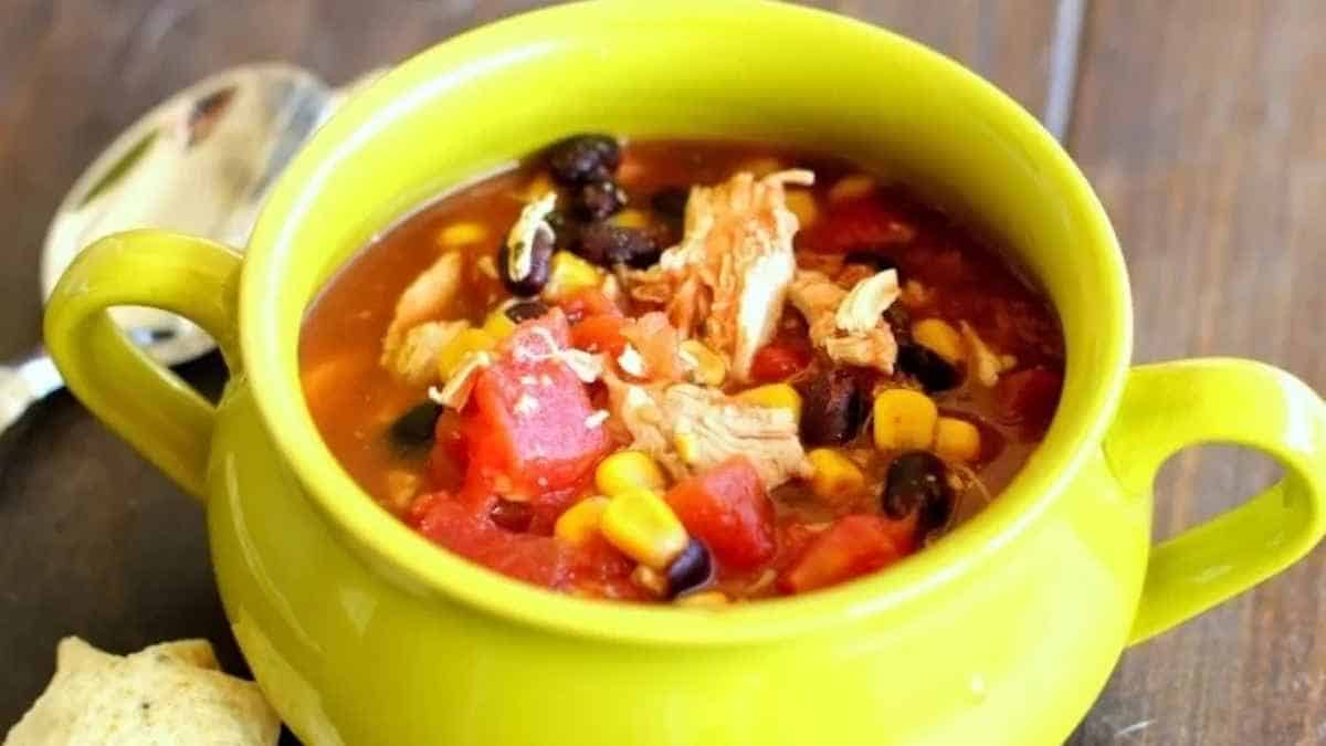 Mexican chicken soup in a green bowl.