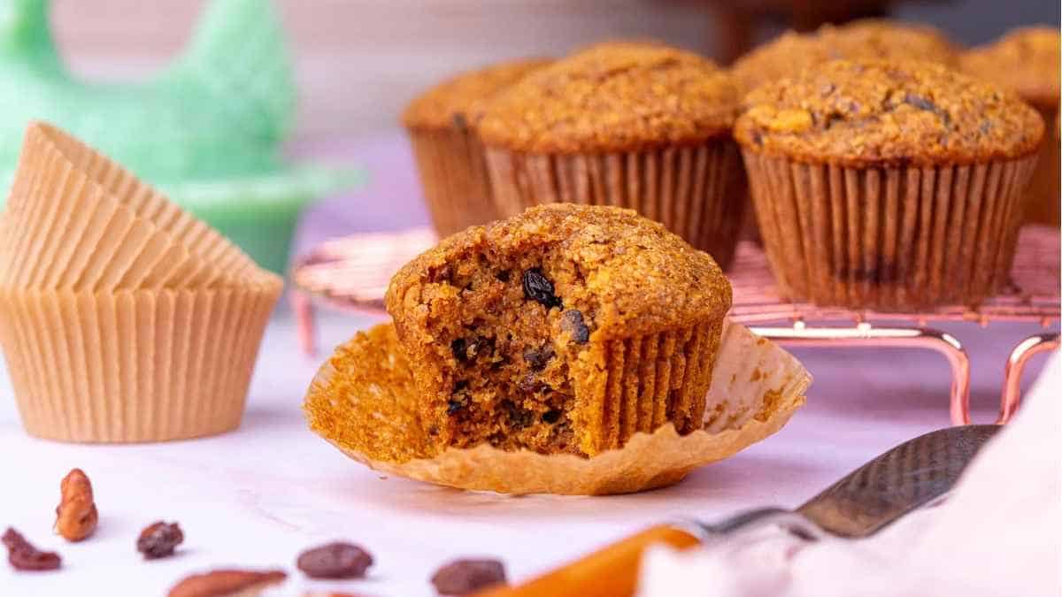 Muffins with raisins and nuts on a plate.