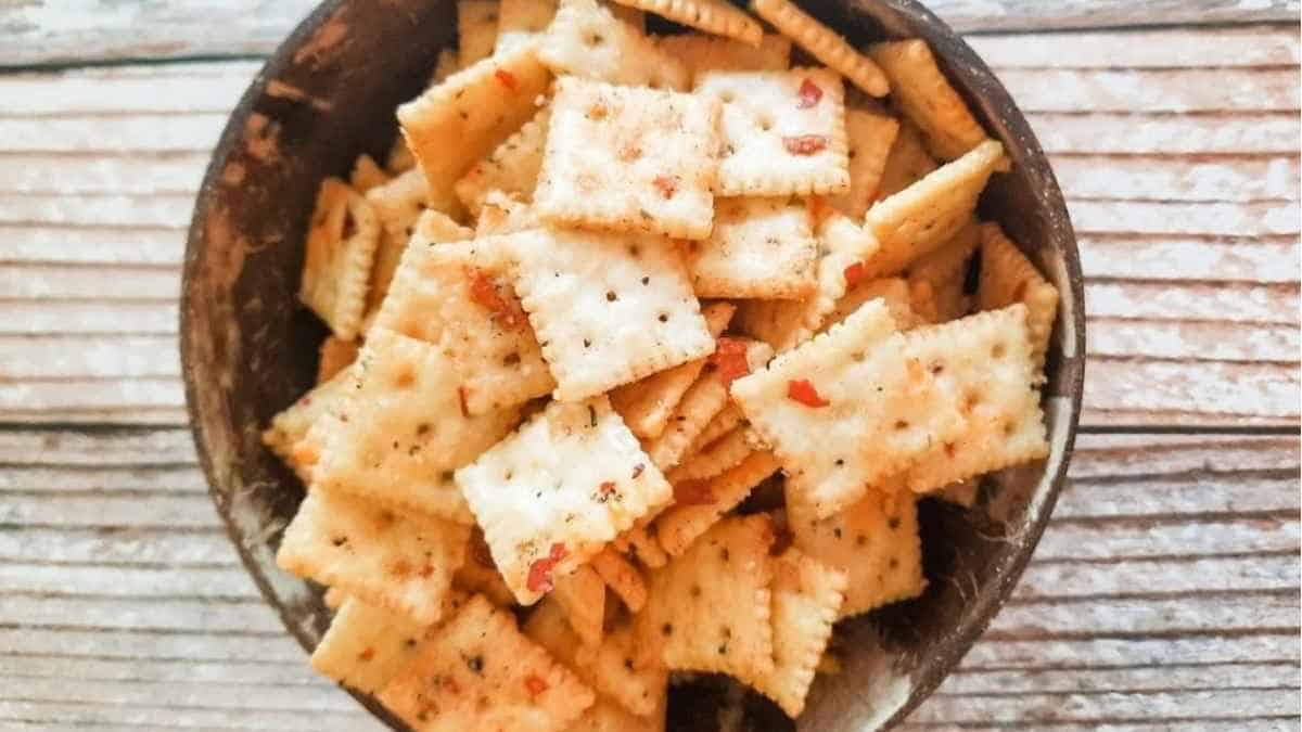 Crackers in a bowl on a wooden table.