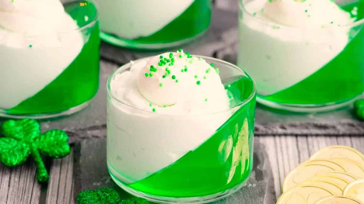 A green and white dessert in a glass cup.