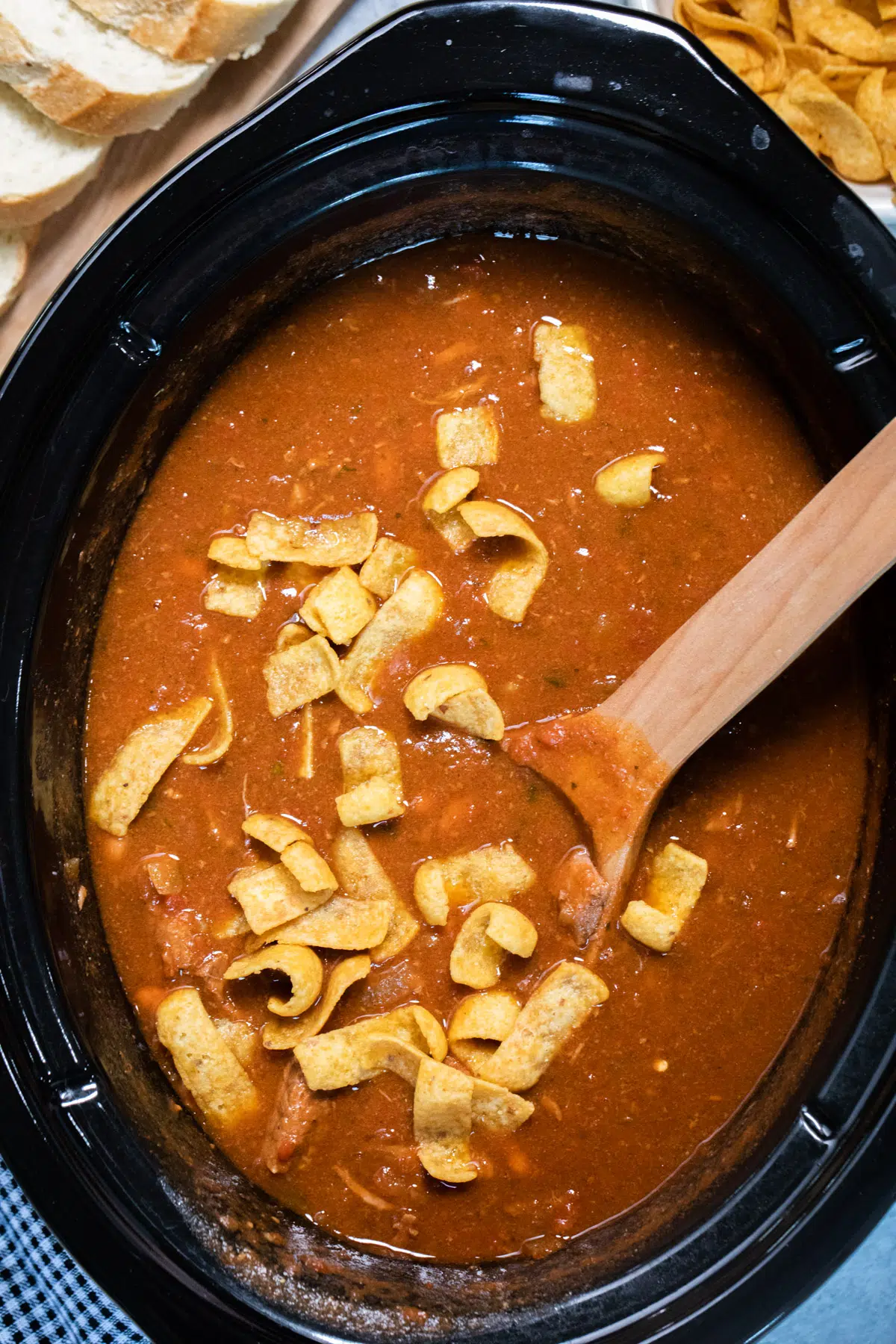 A tantalizing crock pot full of flavorful Mexican stew and tortilla chips.