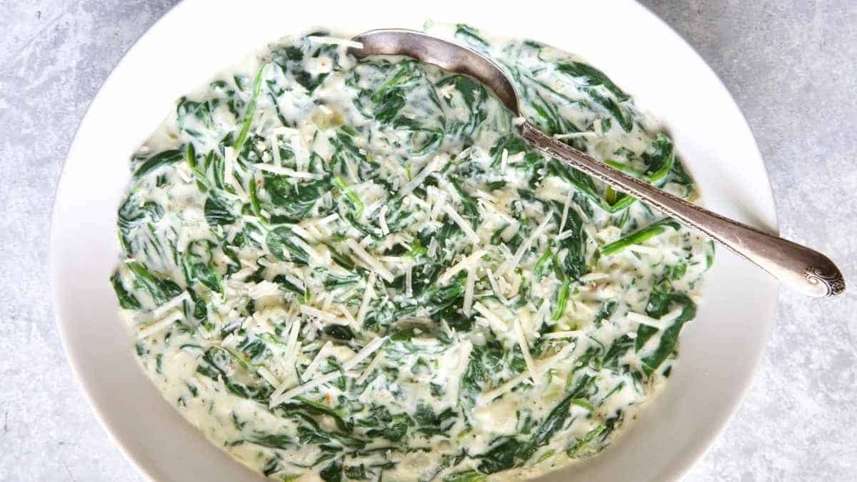 A bowl of spinach and cheese.