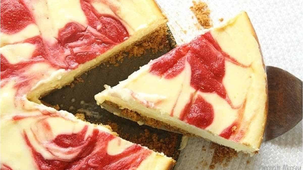 A slice of strawberry cheesecake on a plate.