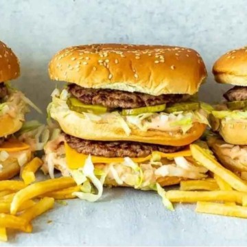 Four burgers and fries are stacked on top of each other.