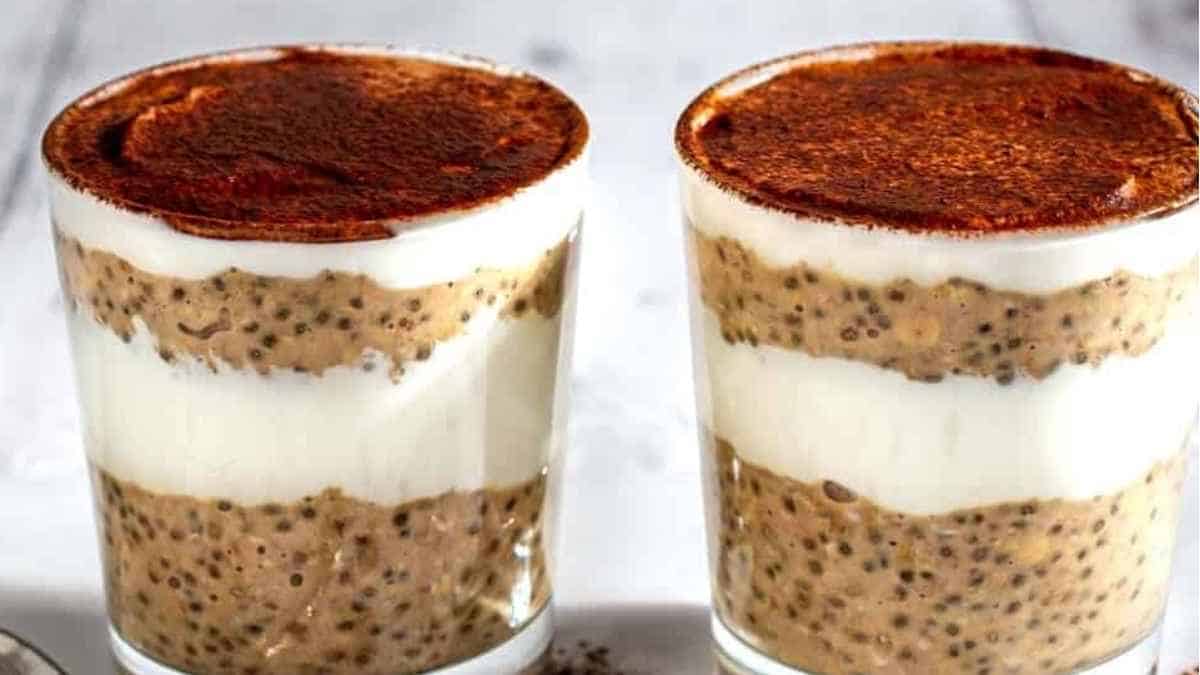 Two glasses of chia pudding on a table.