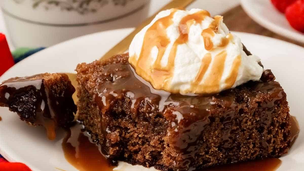 A slice of chocolate cake with whipped cream and caramel sauce.