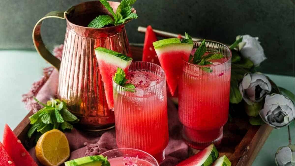 Watermelon cocktail with mint leaves on a tray.