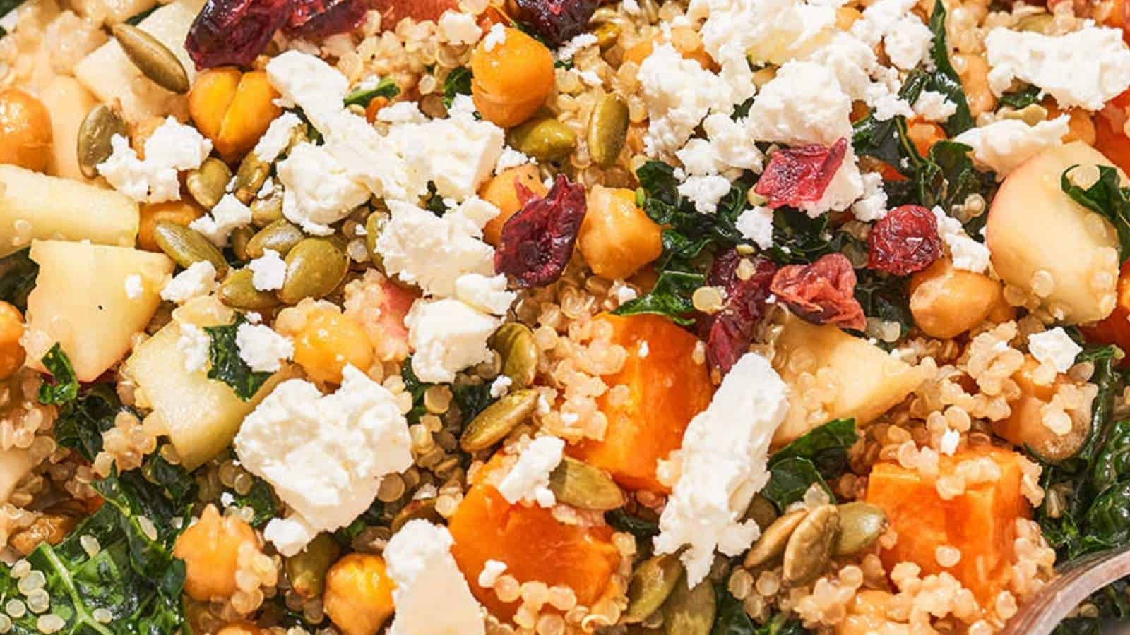 A bowl of quinoa and vegetables with kale and feta.
