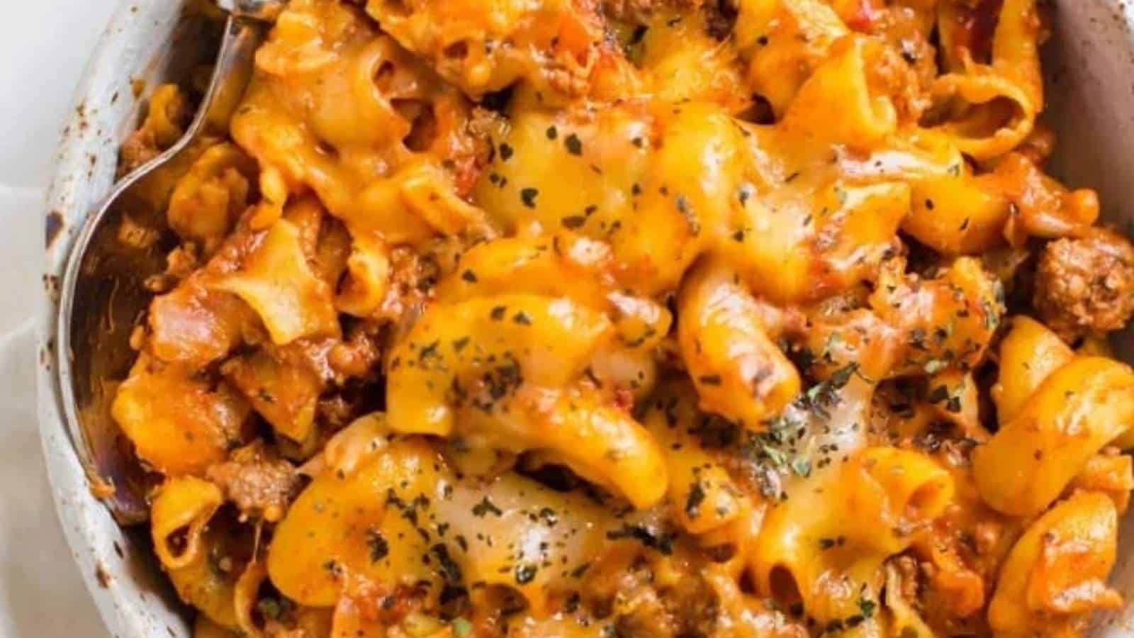 A bowl of pasta with meat and cheese in it.